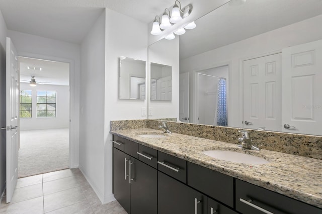 bathroom with tile patterned flooring, a shower with curtain, vanity, and ceiling fan