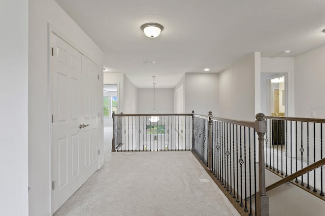 hallway with carpet flooring and visible vents
