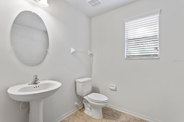 bathroom featuring tile patterned floors and toilet