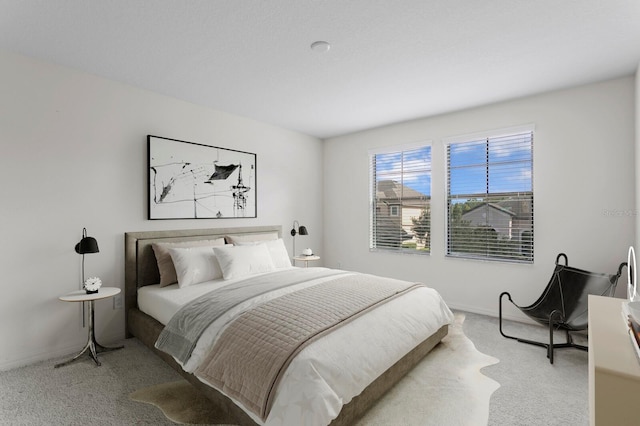 bedroom with carpet floors and baseboards