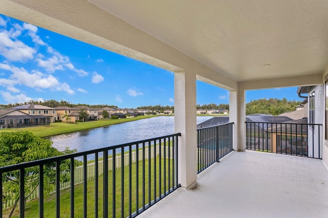 balcony featuring a residential view and a water view
