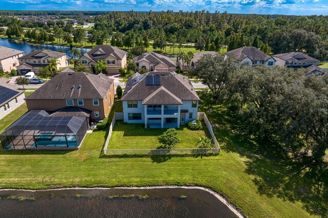 aerial view with a water view, a wooded view, and a residential view
