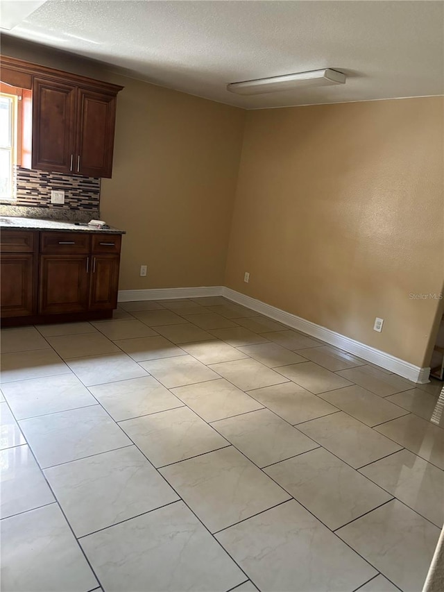 kitchen featuring backsplash and a textured ceiling