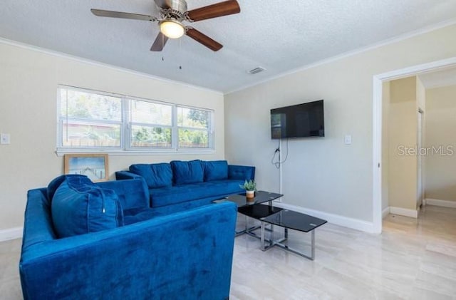 living room with ornamental molding, ceiling fan, and a textured ceiling