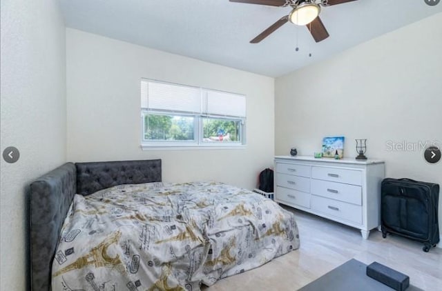 bedroom with light hardwood / wood-style floors and ceiling fan