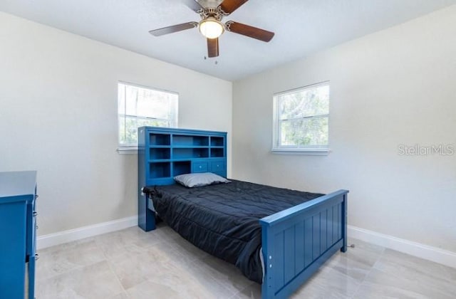 bedroom featuring multiple windows and ceiling fan