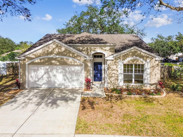 view of front facade with a garage and a front lawn