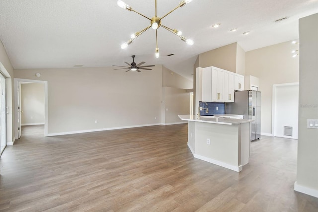 kitchen featuring stainless steel fridge with ice dispenser, white cabinetry, sink, and light hardwood / wood-style floors