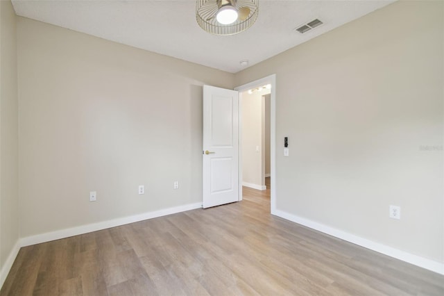 unfurnished room with light wood-type flooring