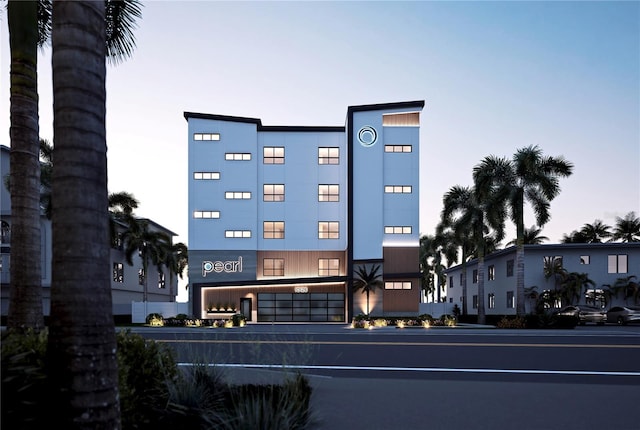 view of outdoor building at dusk