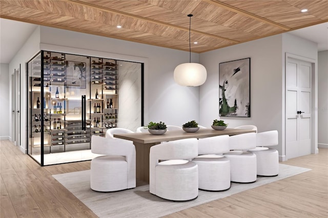 dining area featuring bar area, light wood-type flooring, and wood ceiling