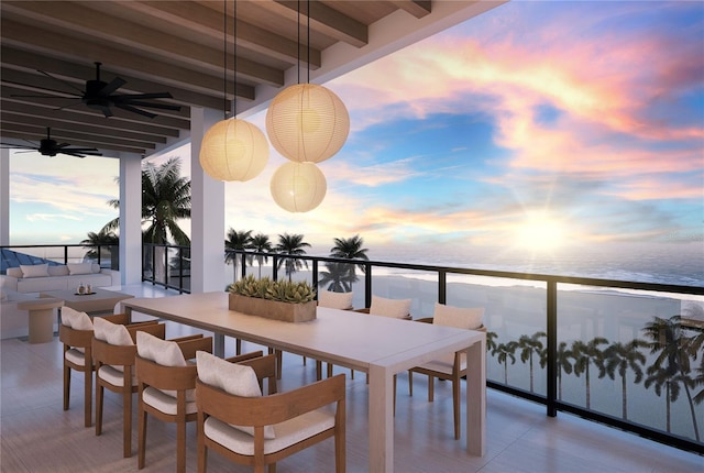 10126 Gulf Blvd Unit Ph1, Treasure Island, FL 33706 - balcony at dusk featuring a water view, a ceiling fan, and outdoor dining area
