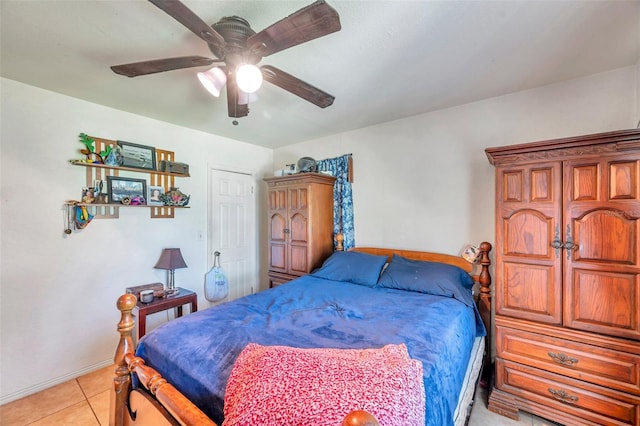 tiled bedroom featuring ceiling fan