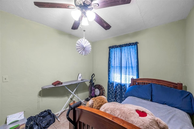 bedroom with ceiling fan and light tile patterned floors