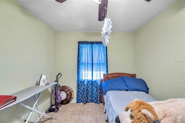 tiled bedroom featuring a textured ceiling and ceiling fan