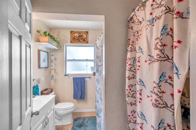 bathroom with a shower with curtain, vanity, tile patterned flooring, and toilet