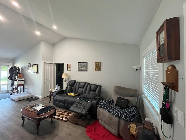 living room with lofted ceiling and light hardwood / wood-style flooring