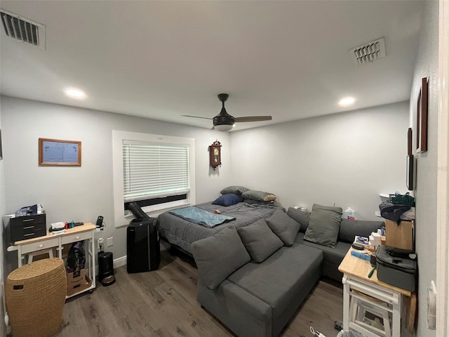 bedroom with ceiling fan and hardwood / wood-style flooring