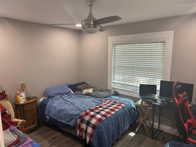 bedroom featuring ceiling fan and dark hardwood / wood-style floors