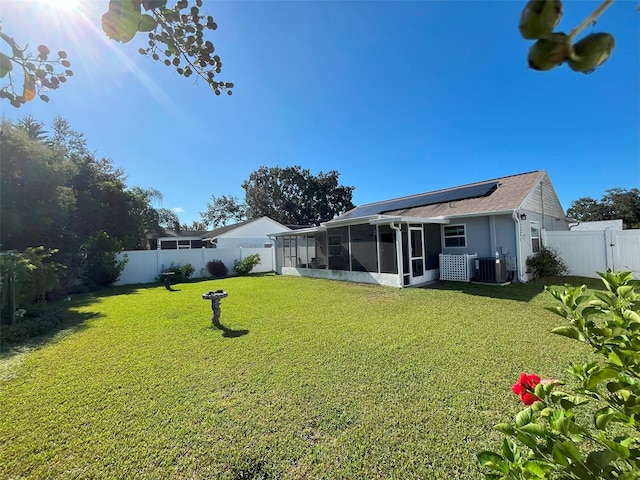 view of yard with a sunroom and central AC