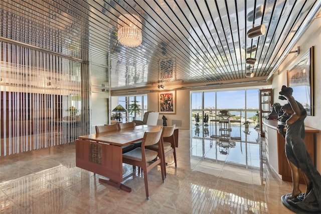 dining room with a water view and a healthy amount of sunlight