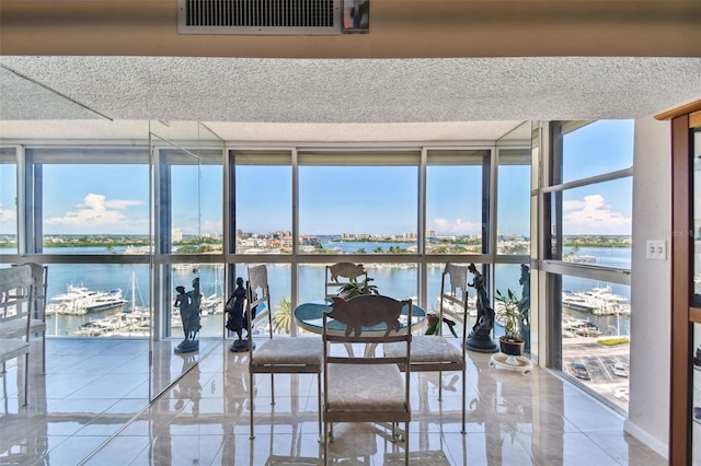 unfurnished sunroom featuring a water view and plenty of natural light