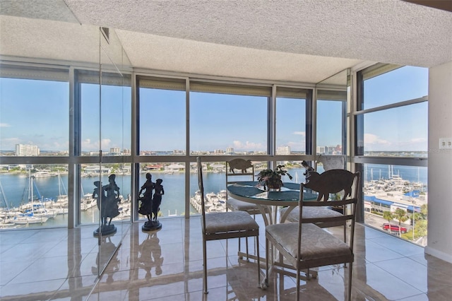 sunroom featuring a water view and plenty of natural light