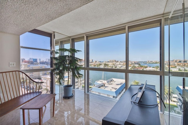 sunroom featuring a water view and plenty of natural light