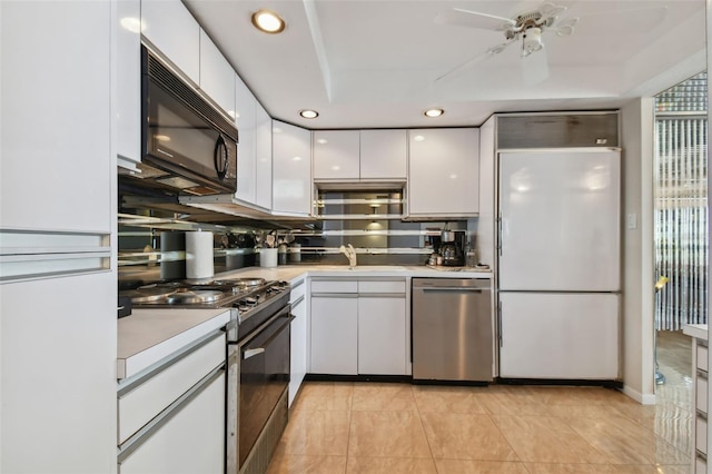 kitchen featuring ceiling fan, white cabinets, light tile patterned flooring, sink, and white appliances