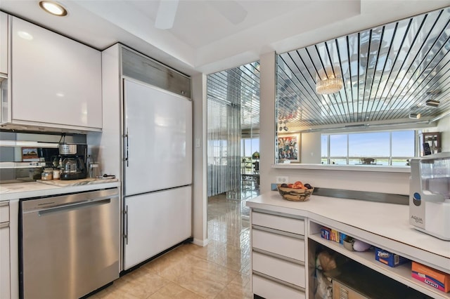 kitchen featuring dishwasher, white built in refrigerator, and white cabinetry