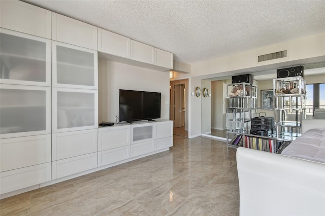 unfurnished living room with a textured ceiling