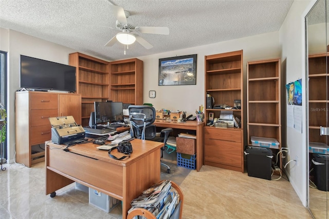 office featuring ceiling fan and a textured ceiling