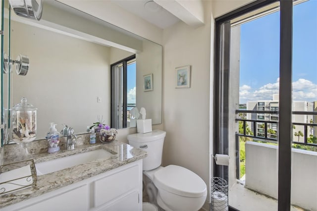 bathroom featuring vanity and toilet