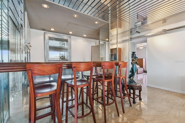 bar featuring stainless steel fridge