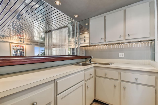 kitchen featuring white cabinets and sink