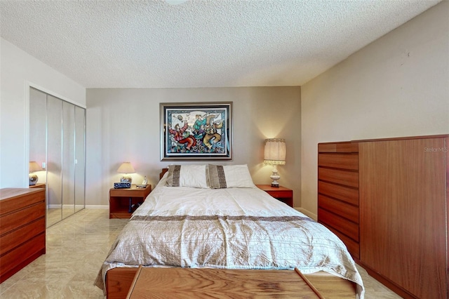 bedroom with a closet and a textured ceiling