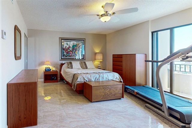 bedroom featuring ceiling fan and a textured ceiling