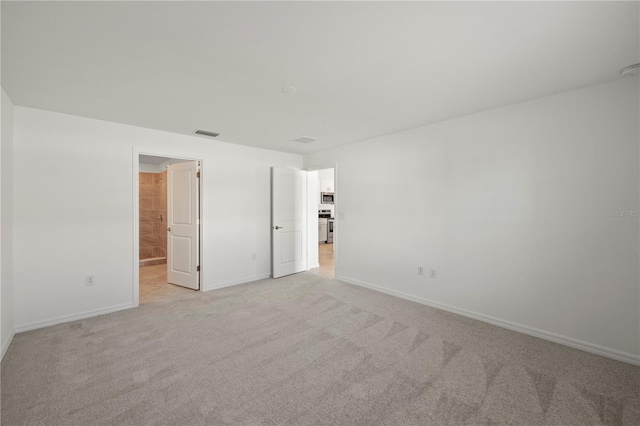 unfurnished bedroom featuring light carpet