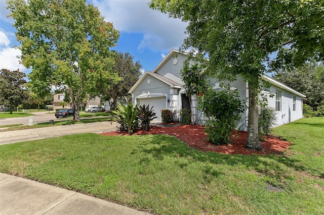 view of front facade with a front yard and a garage