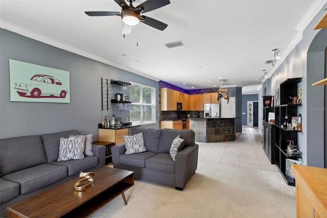 tiled living room featuring ceiling fan and crown molding