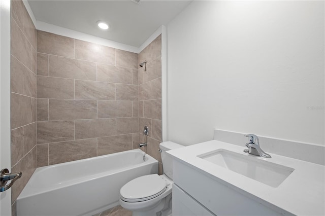 full bathroom featuring tiled shower / bath, vanity, and toilet