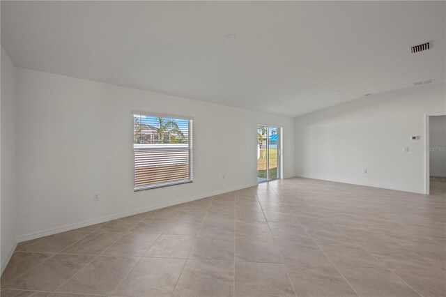 spare room featuring light tile patterned floors