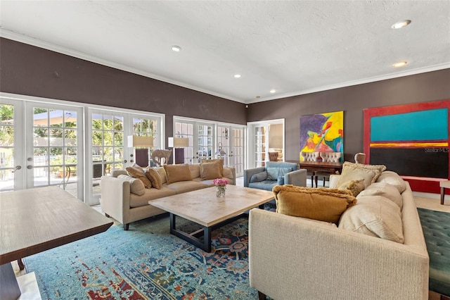 living room with a textured ceiling, a healthy amount of sunlight, ornamental molding, and french doors