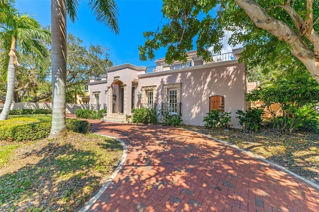 mediterranean / spanish-style home with covered porch