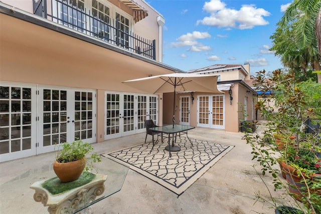 view of patio featuring a balcony and french doors