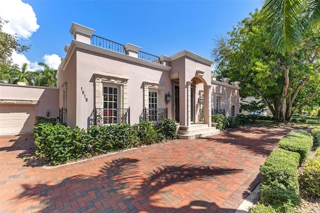 view of front of property with a balcony and a garage