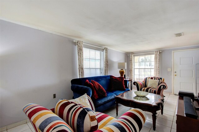 living room featuring ornamental molding, light tile patterned floors, and a healthy amount of sunlight