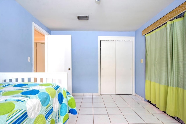 tiled bedroom featuring a closet