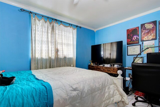 bedroom with ornamental molding and ceiling fan