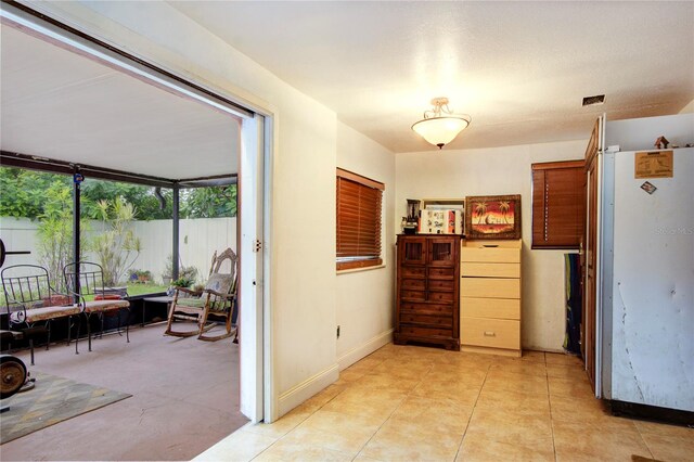 kitchen featuring light tile patterned flooring and white fridge